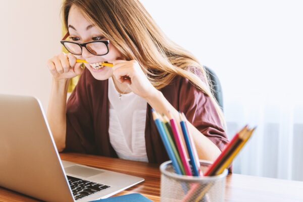 Woman biting pencil